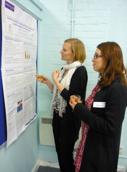 Researchers reading a research poster
